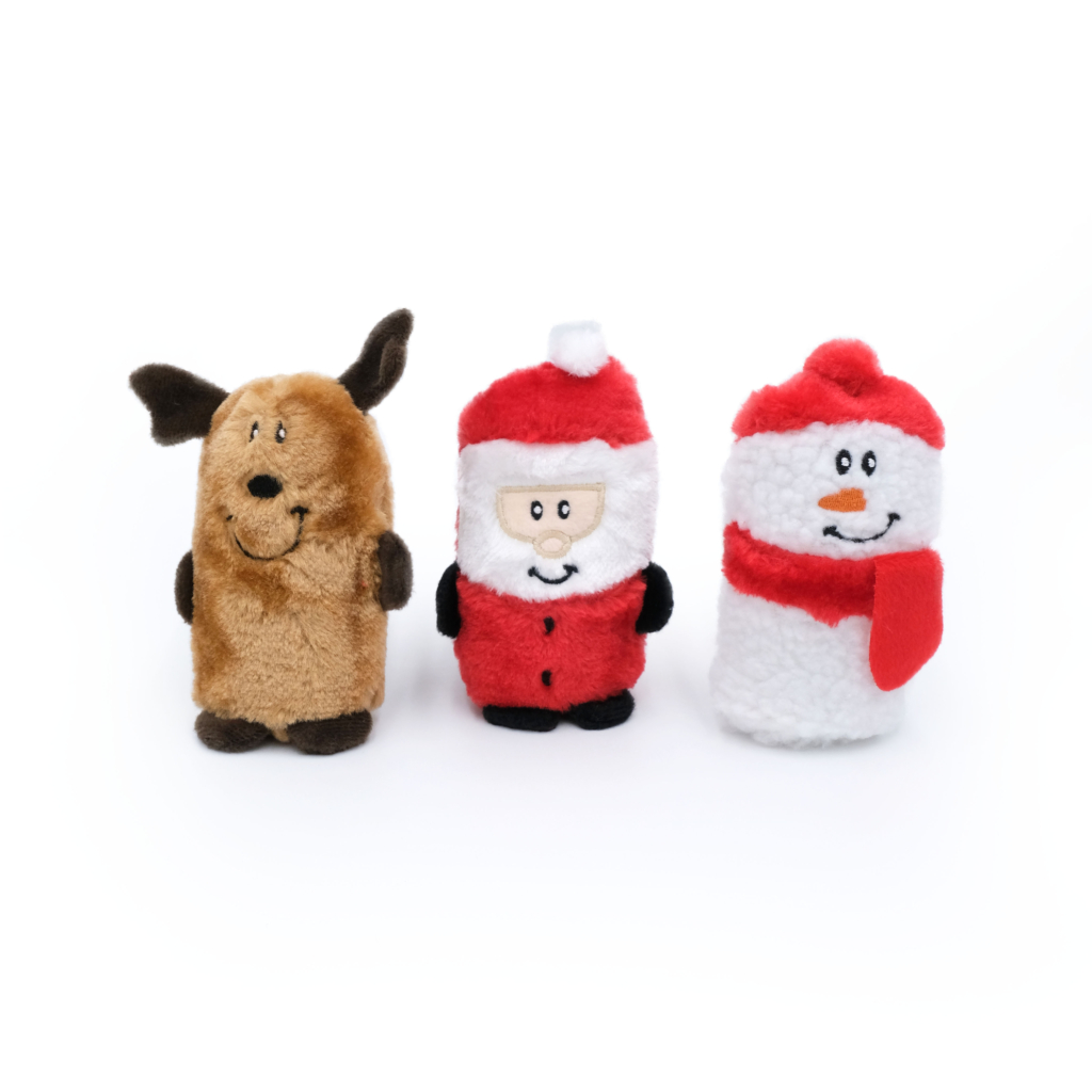 Three Holiday Squeakie Buddies - Pack of 3 stand in a row: a brown dog, a Santa Claus figure, and a white snowman with a red hat and scarf.