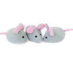 Three gray plush toy mice with pink ears and tails are arranged in a row.