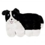 A soft, plush toy resembling a black and white dog with a happy expression, displaying its tongue.