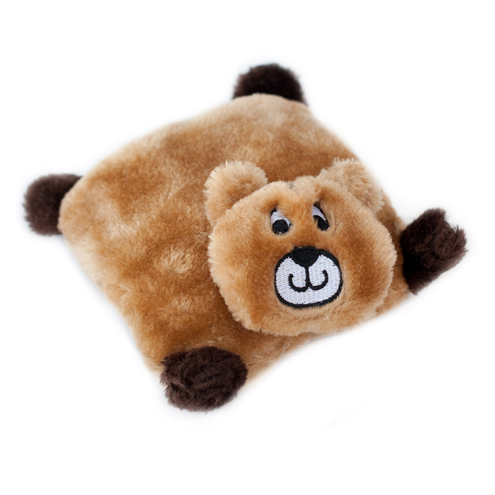 A plush toy resembling a square-shaped bear with a brown body, dark brown ears, and limbs, and a smiling face embroidered on the front.