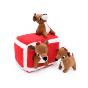 Three Holiday Burrow® - Reindeer Pen toys with red and white accents: one on top of a rectangular plush block, one inside the block, and one standing beside it.