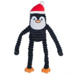 A plush toy with a black body, long coiled arms and legs, an embroidered face with a beak, orange feet, and a red Santa hat.
