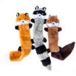 Three plush dog toys resembling different animals: a red fox, a raccoon, and a brown fox, laid out side by side against a white background.
