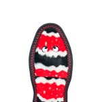 The image shows the sole of a colorful slipper with a wavy red, black, and white pattern and two small white eyes near the top.