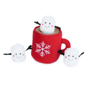A red plush mug with a white snowflake design containing a smiling plush marshmallow, accompanied by two additional plush marshmallows with stick arms and happy faces outside of the mug.