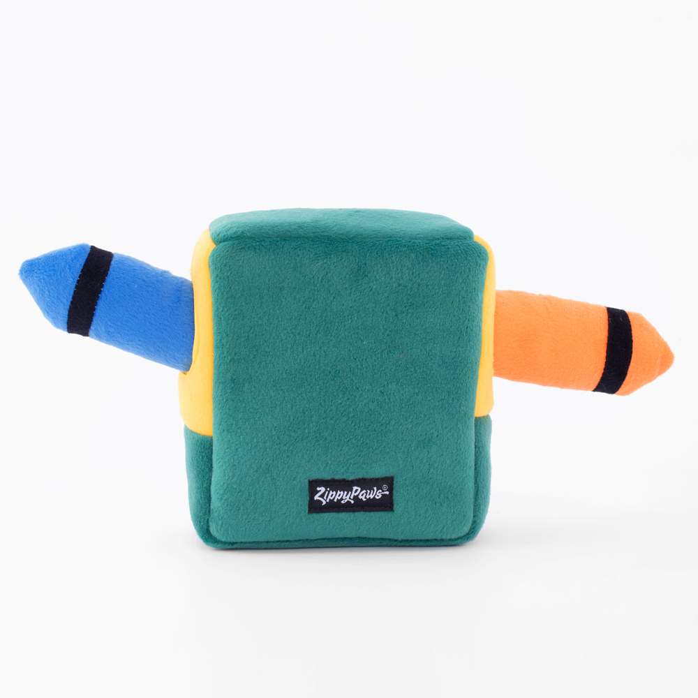 A square green plush toy with two protruding crayon shapes, one blue and one orange, labeled 
