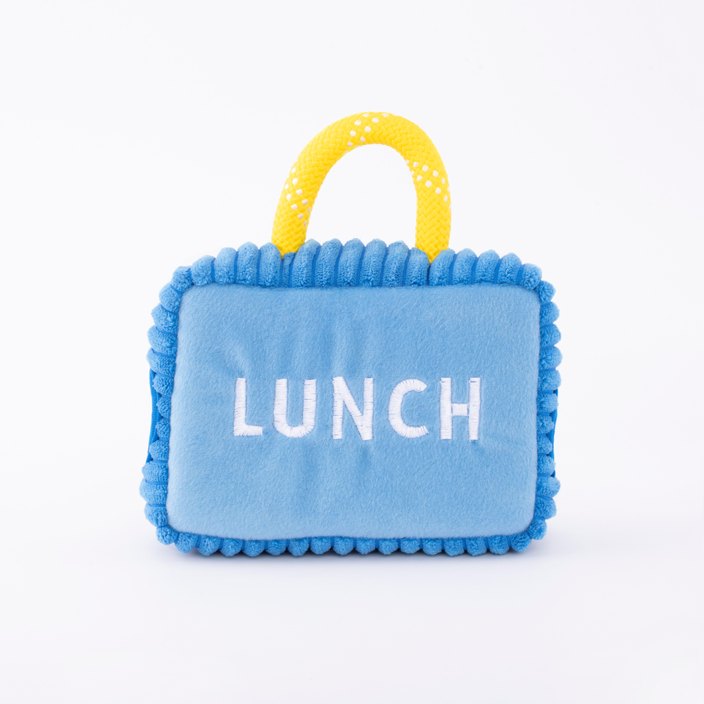 A blue plush lunch bag with a yellow handle, embroidered with the word 