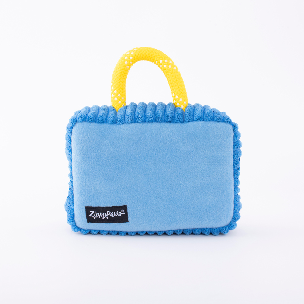 A rectangular blue plush dog toy with a yellow handle and a 