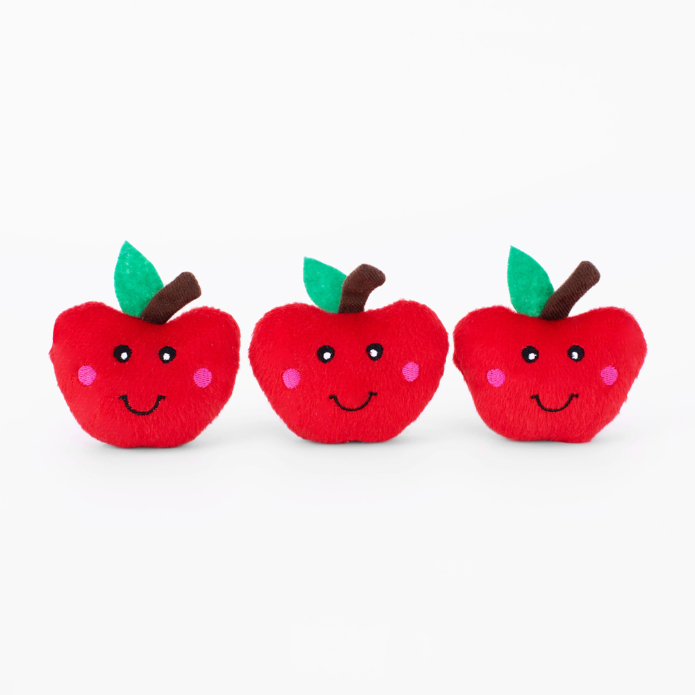 Three red apple-shaped plush toys with smiling faces and green felt leaves on white background.