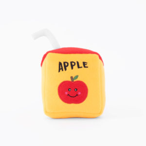A plush toy shaped like an apple juice box with a red top, white straw, and the word "APPLE" along with a smiling red apple illustration on the front.