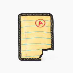Photo of a yellow notebook page with blue lines and a red "A" grade. The shape is bordered by black stitching and has a bite-like cut on the bottom edge.