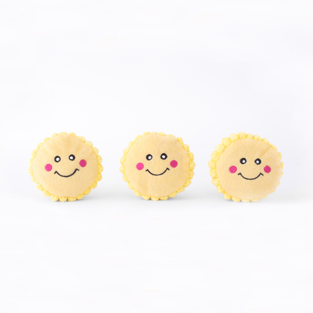 Three yellow plush toys with smiling faces and rosy cheeks lined up in a row against a white background.
