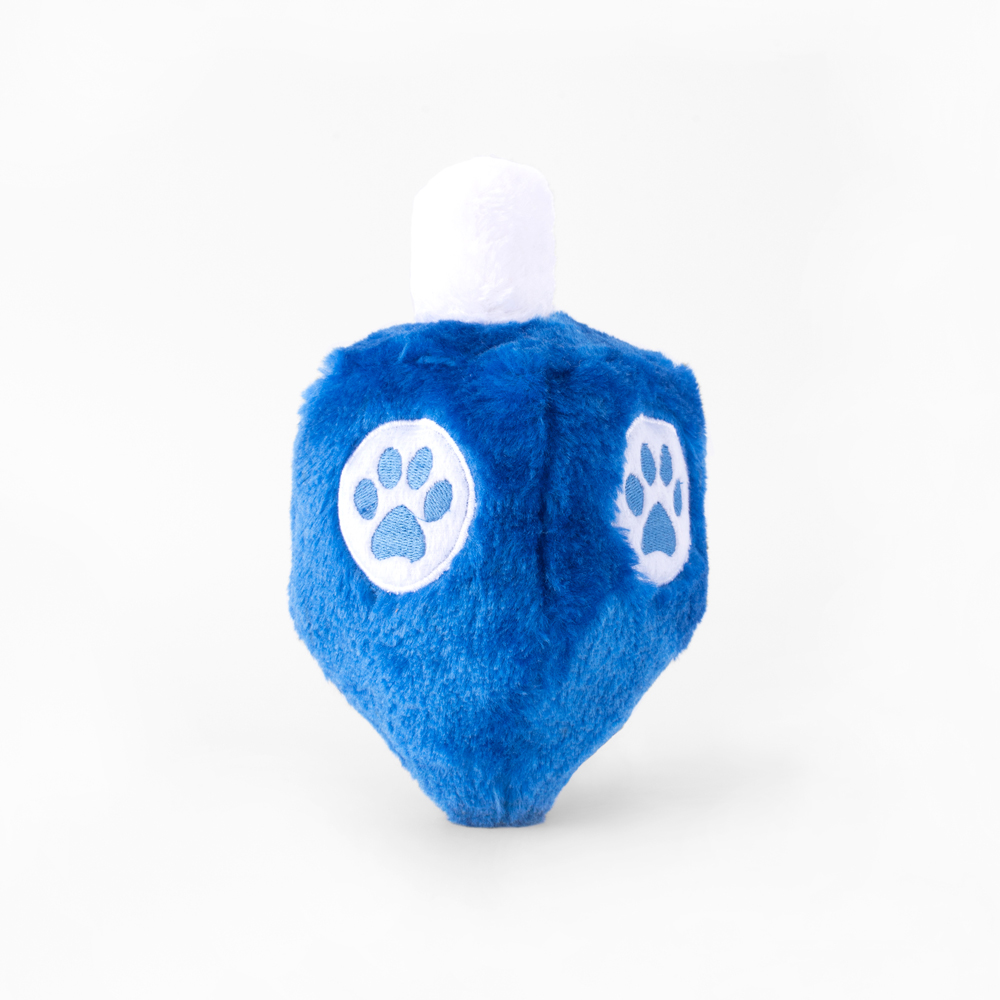 A blue, plush toy shaped like a dreidel, featuring white paw print symbols on its sides.