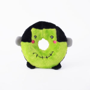 A green plush toy shaped like a ring with black hair, small gray arms, rosy cheeks, a stitched mouth, and black feet, resembling a cute, cartoonish Frankenstein's monster.
