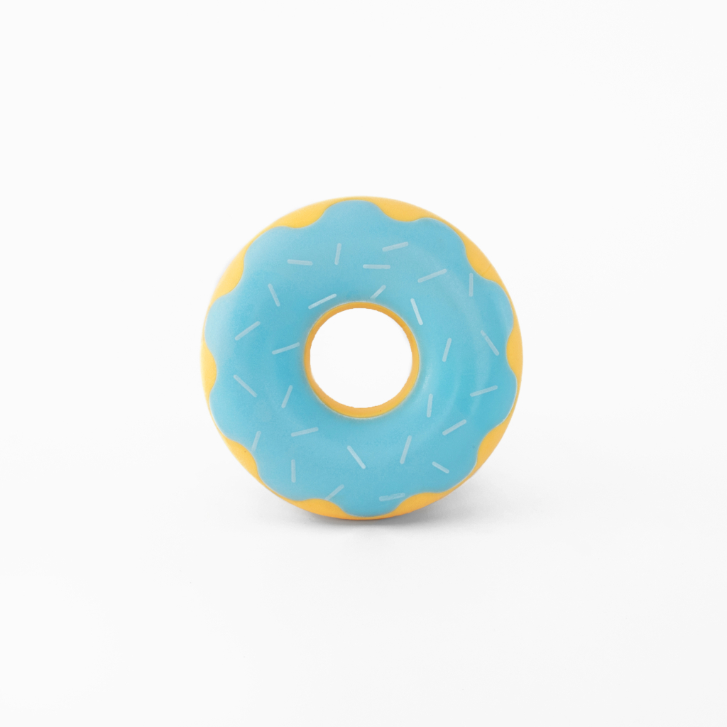 A rubber donut-shaped toy with a light blue surface, white sprinkles, and a yellow wavy pattern along the edge. The toy is centered on a white background.