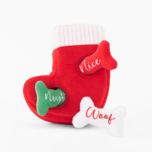 A red plush Christmas stocking toy with "Nice" written on a red bone, "Naughty" on a green fish bone, and "Woof" on a white bone, designed for pets.
