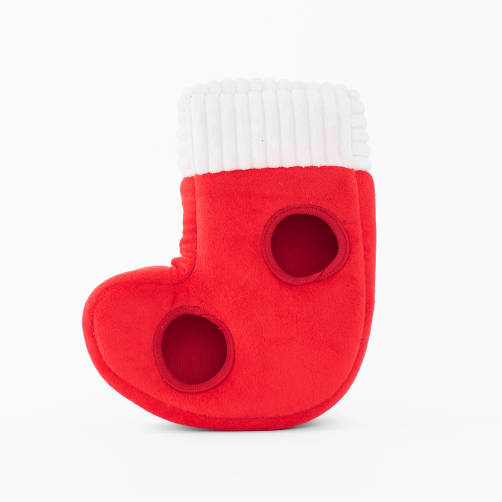 Red plush Christmas stocking with white cuff and two circular cutouts on the side.