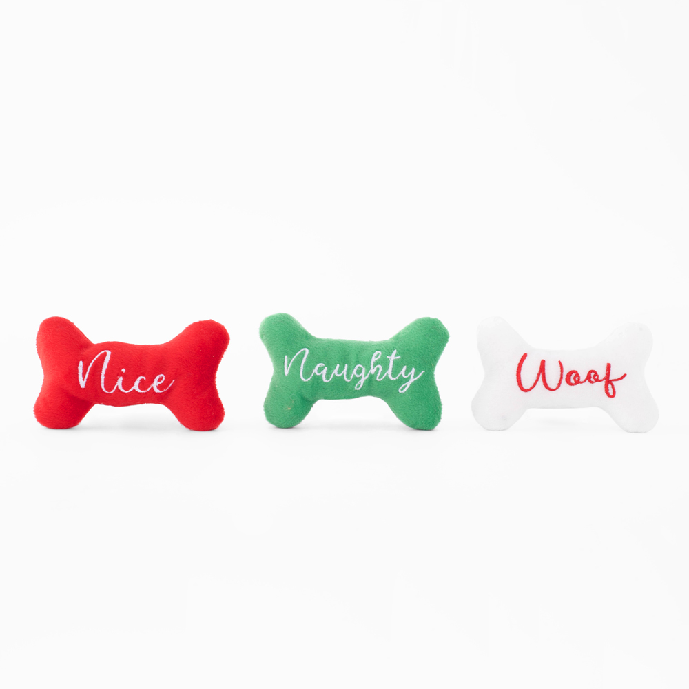Three plush dog bone toys in red, green, and white colors with the words 
