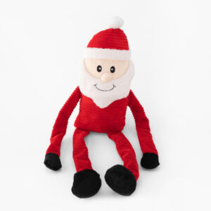 A plush toy Santa Claus with a white beard, red hat and outfit, and black feet sits against a white background.