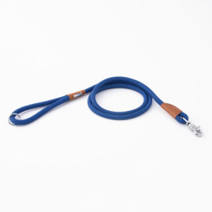 A blue rope dog leash with a silver clasp and brown leather accents is laid out on a white background.