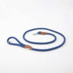 A blue and white patterned dog leash with a metal clasp and brown leather details, coiled on a white background.