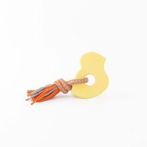 A yellow loop-shaped dog toy with an orange and gray rope attached.