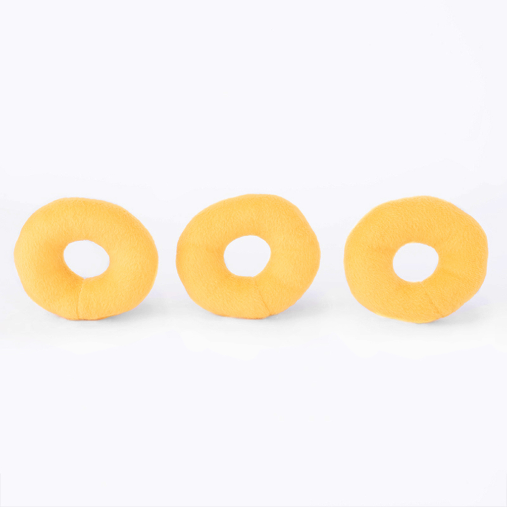 Three yellow doughnut-shaped plush toys arranged in a horizontal line against a plain white background.