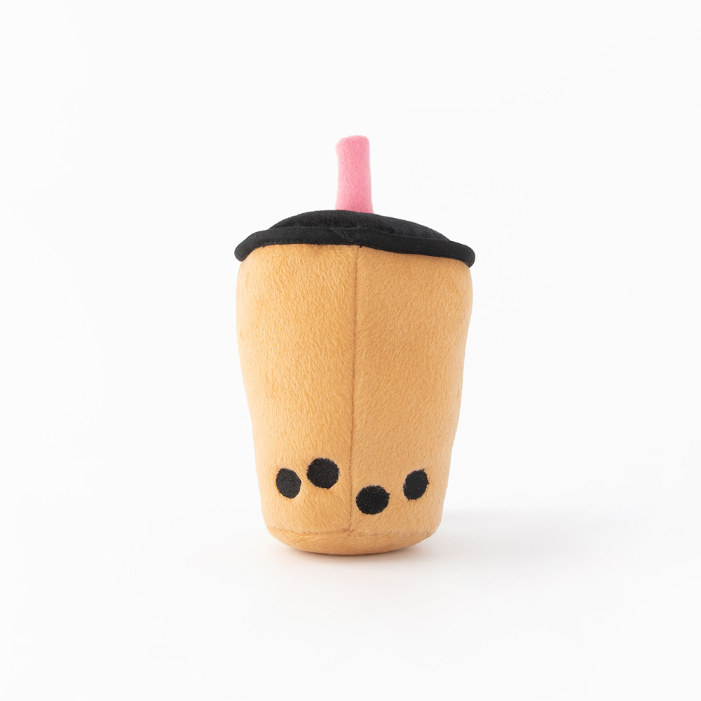 A plush toy designed to resemble a bubble tea cup, with a light brown body, black 