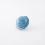 A small blue plastic toy helmet with a circular shape and mild scuff marks on a white background.