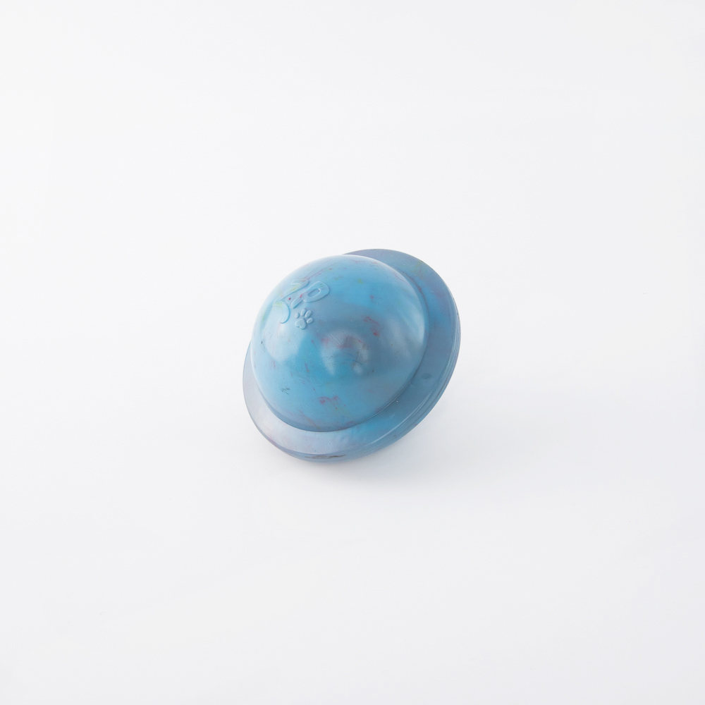 A small blue plastic toy helmet with a circular shape and mild scuff marks on a white background.