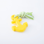 Yellow anchor-shaped dog toy with white and green rope attached on a white background.