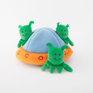 Three green plush aliens with antennae around a soft, blue and orange plush UFO toy.