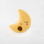 A yellow crescent moon-shaped plush with a sleeping face embroidered on it and a small opening at the bottom right, set against a plain white background.