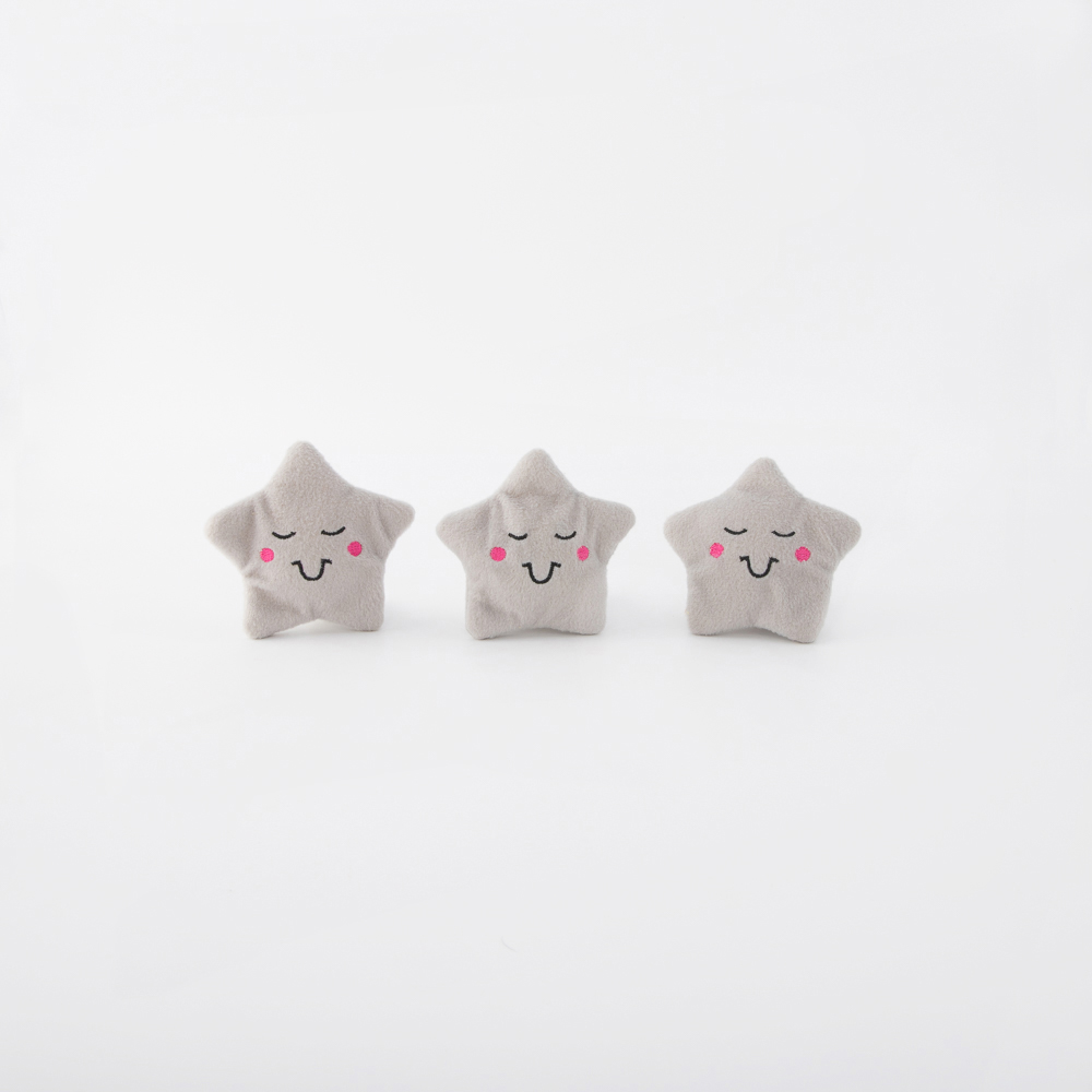 Three plush star-shaped toys with smiling faces and rosy cheeks are arranged in a row on a white background.