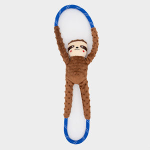 A plush toy shaped like a brown sloth with a blue and white-spotted loop attached to its hands and feet, photographed on a white background.