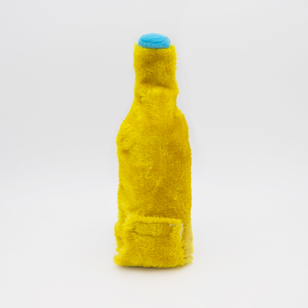 A yellow plush toy shaped like a bottle with a small blue cap, standing upright against a plain white background.