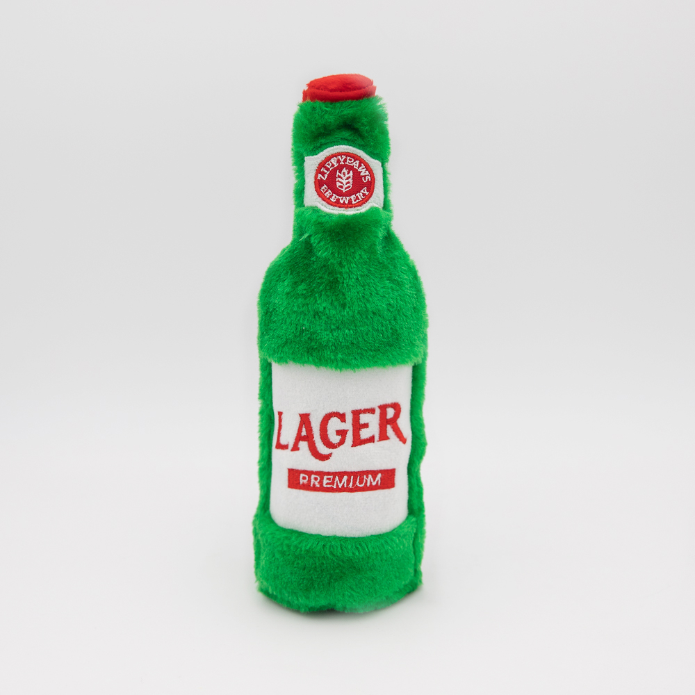 A green plush toy shaped like a beer bottle with a label that reads 