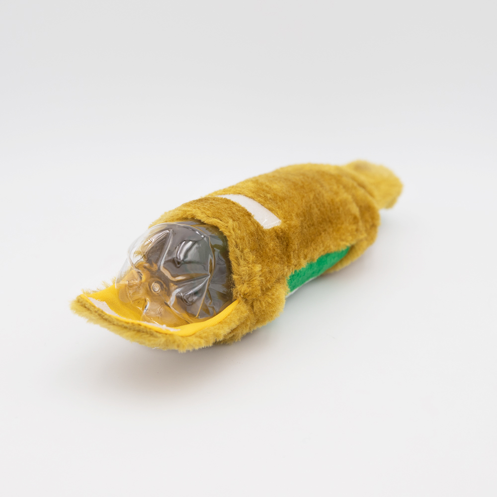 A yellow plush toy with a plastic bottle partially inserted inside on a white background.
