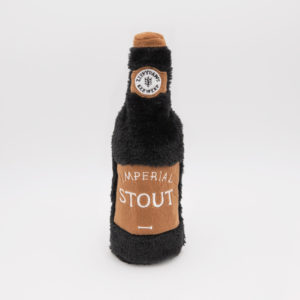 A plush toy resembling a bottle of Imperial Stout beer, featuring a brown body with a label reading "Imperial Stout" and a faux bottle cap with a logo.