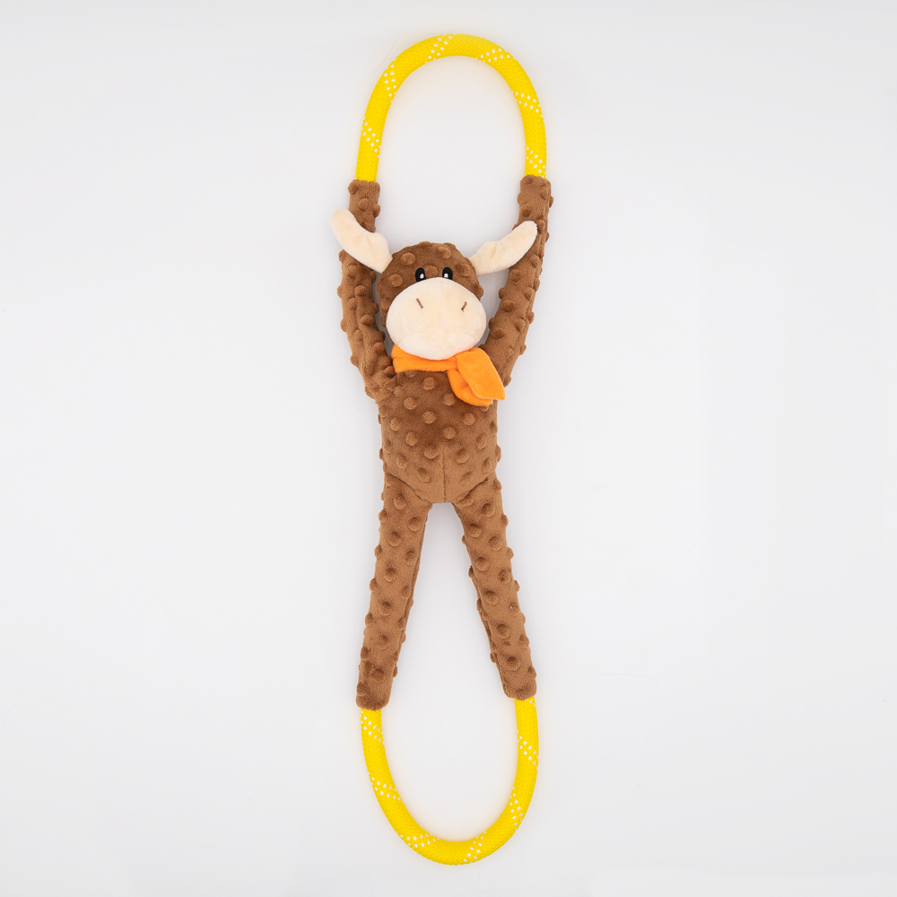 A plush toy resembling a brown animal with long limbs is attached to a yellow and white polka-dotted loop, lying on a white background.