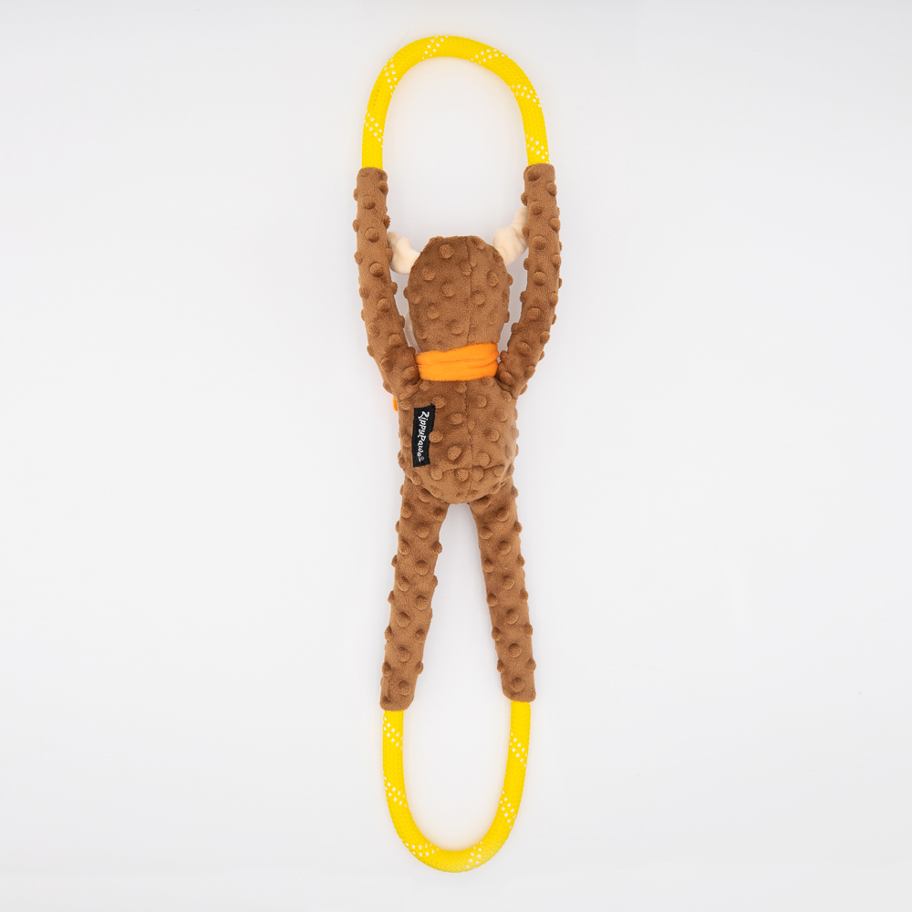 A plush toy shaped like a brown animal, possibly a monkey, with a long yellow loop attached to its hands and feet, lying on a white surface.