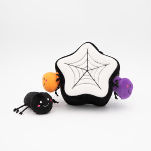 Three plush toys resembling black, orange, and purple spiders surround a star-shaped plush with a spider web design on the front.