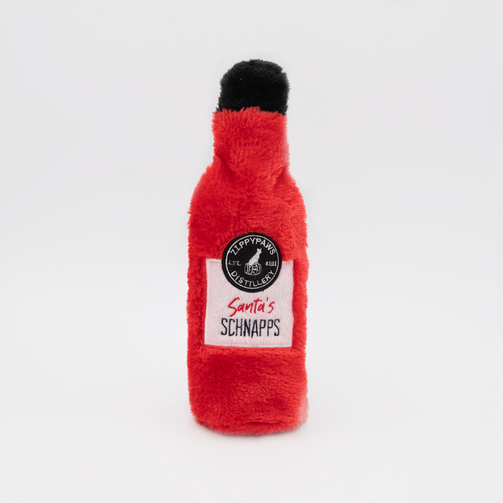 A plush toy shaped like a red bottle with a black cap, labeled 