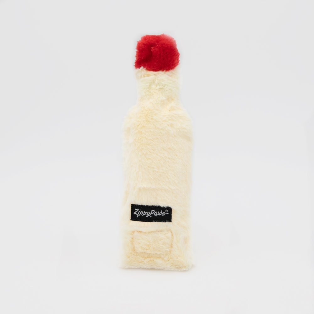 A white plush toy resembling a bottle with a red cap and a black label that reads 