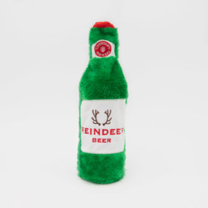 A plush toy shaped like a green beer bottle with a red cap, labeled "Reindeer Beer" featuring an image of antlers.