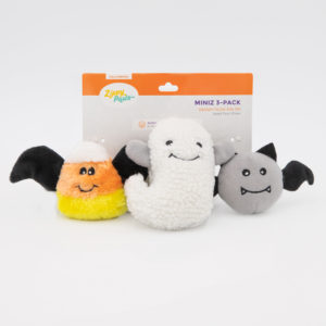 A pack of three Halloween-themed plush dog toys shaped like a candy corn bat, a white ghost, and a gray bat. The packaging reads "Zippy Paws Miniz 3-Pack.