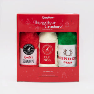 A box set of three Christmas-themed dog toys named "Santa’s Schnapps," "Elf Nog," and "Reindeer Beer" from ZippyPaws. The packaging is red with festive designs and white text.