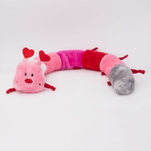Plush toy resembling a caterpillar with sections in red, pink, and grey. The toy has heart-shaped antennae and a face with embroidered features.