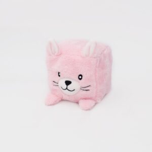 A square-shaped, pink plush toy with rabbit-like features including ears, a nose, and whiskers, positioned against a plain white background.