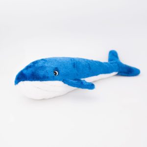 A plush blue and white whale toy with a small fin and a smiling face sits on a plain white background.